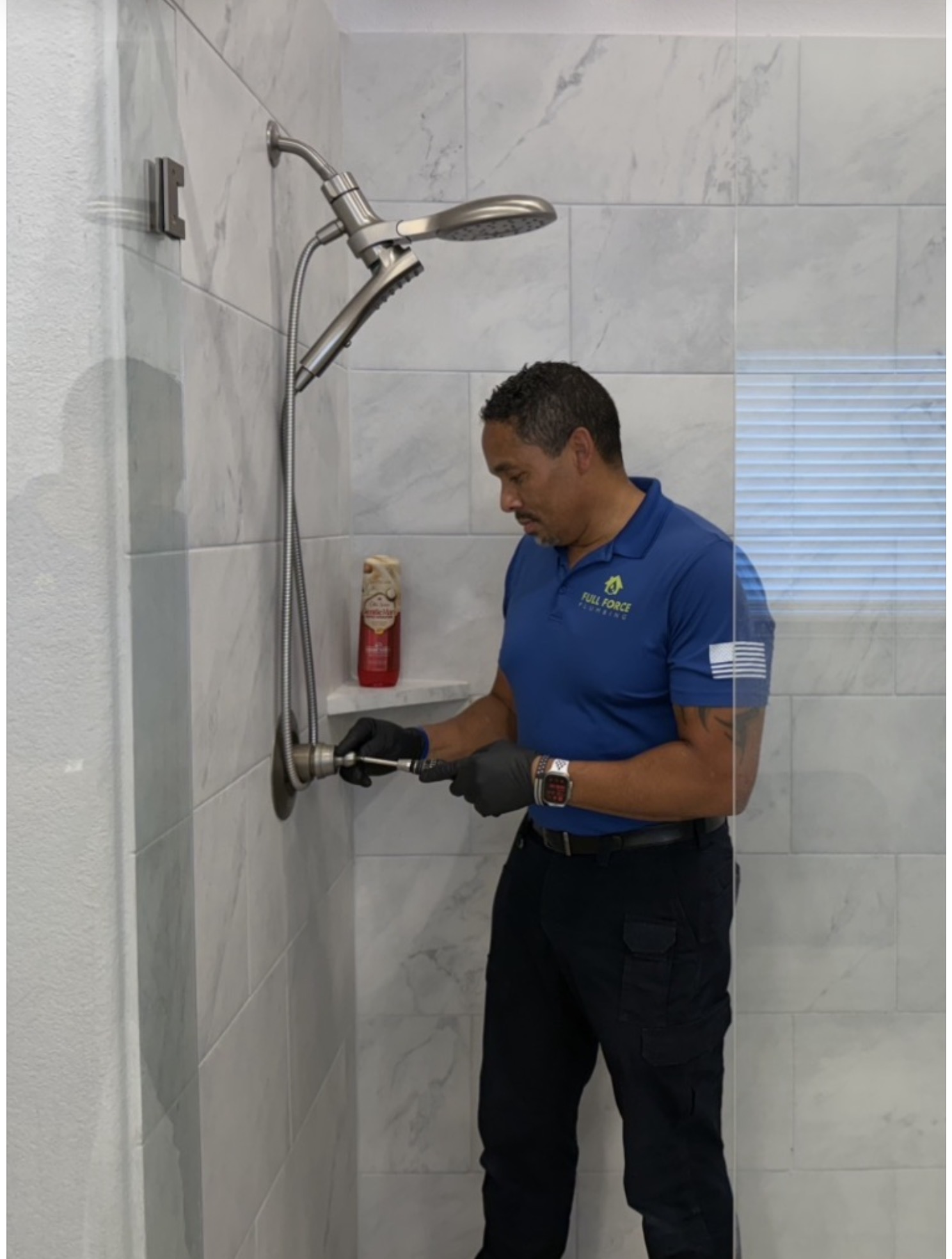 Full Force Plumbing technician servicing a shower fixture